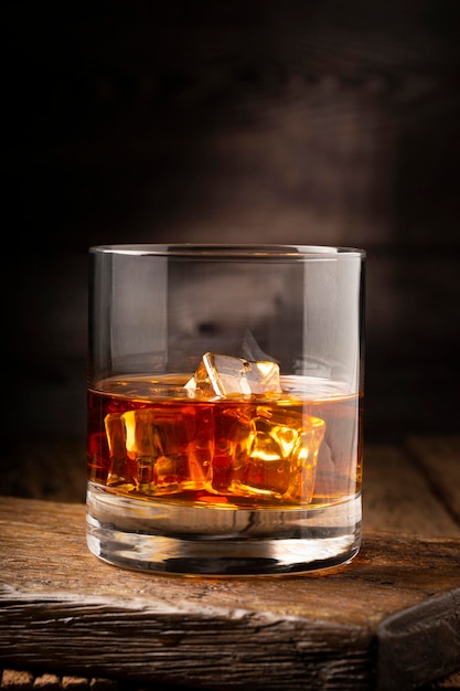 Glass with whiskey and ice cubes