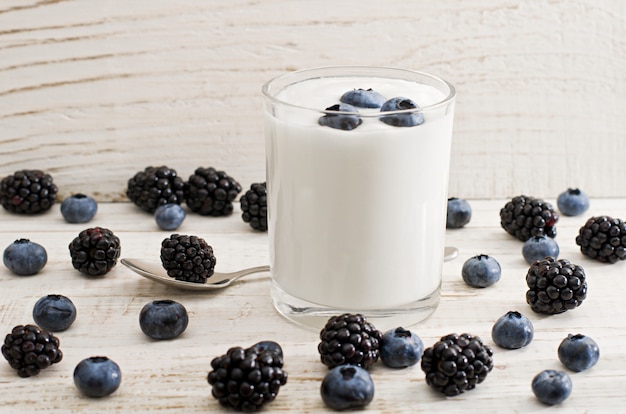 Glass of yogurt with blueberries, blackberries and blueberries