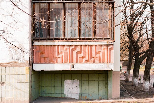 Glassed soviet balcony on the first floor of the old building Design Architecture Style USSR Tree House Outdoor City History Concrete