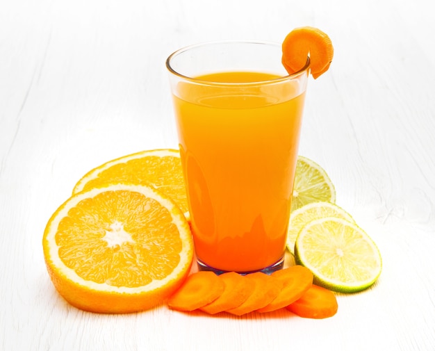 Glasses of ace  juice with carrot,orange and lemon