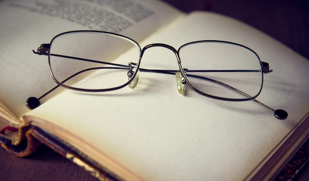 Glasses are on an open old book