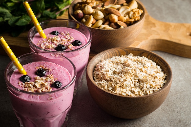 Glasses of berry smoothie with nuts. 