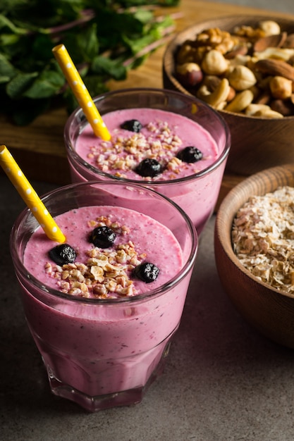 Glasses of berry smoothie with nuts. 