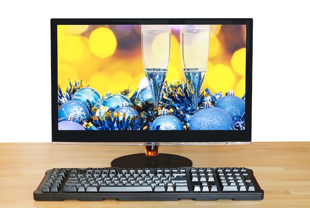 Glasses and blue baubles on screen of monitor