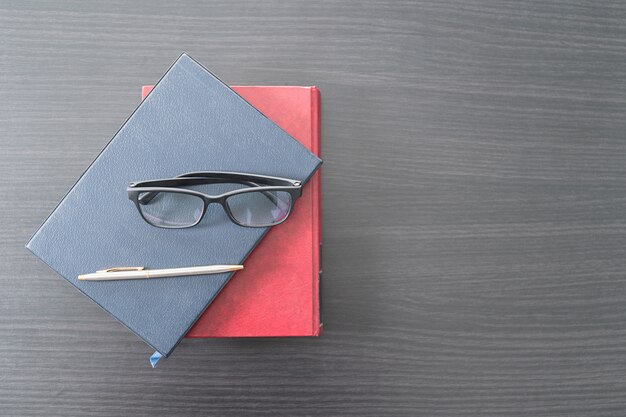 Glasses and book on the wood desk