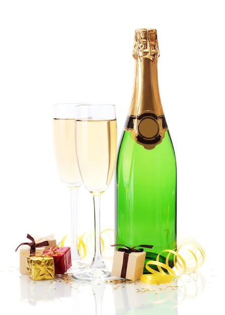 Glasses and bottle of champagne, gifts and serpentine isolated on a white