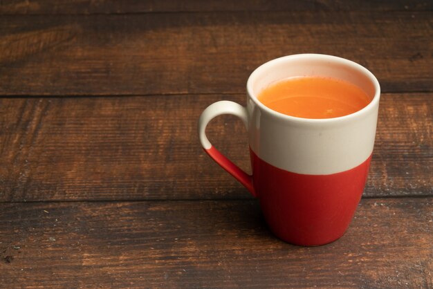 Glasses of carrot juice with vegetables on table close up