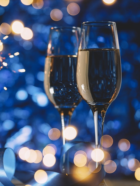 Glasses of champagne on a festive blue decoration