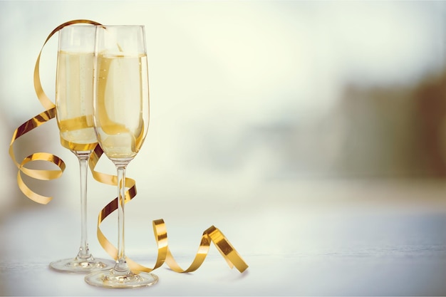 Glasses of champagne with curly golden ribbon