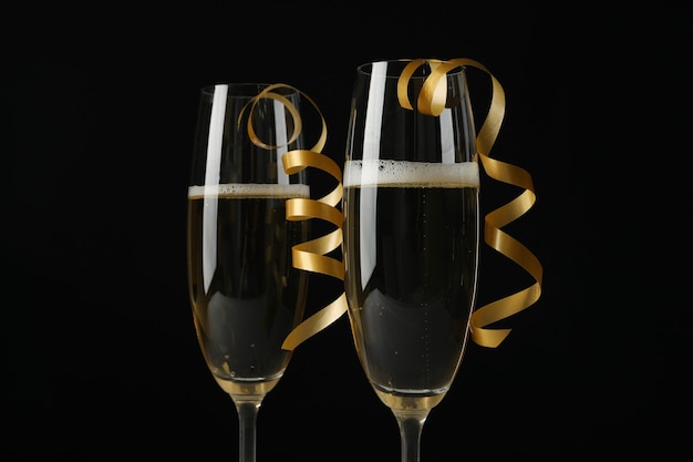 Glasses of champagne with curly ribbons