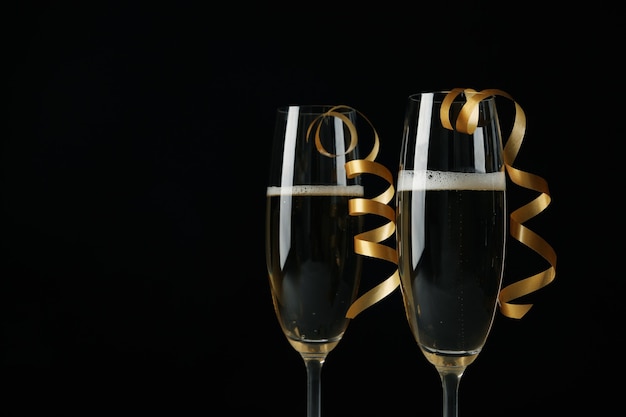 Glasses of champagne with curly ribbons