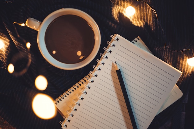 Glasses and coffee are placed on the notebook.