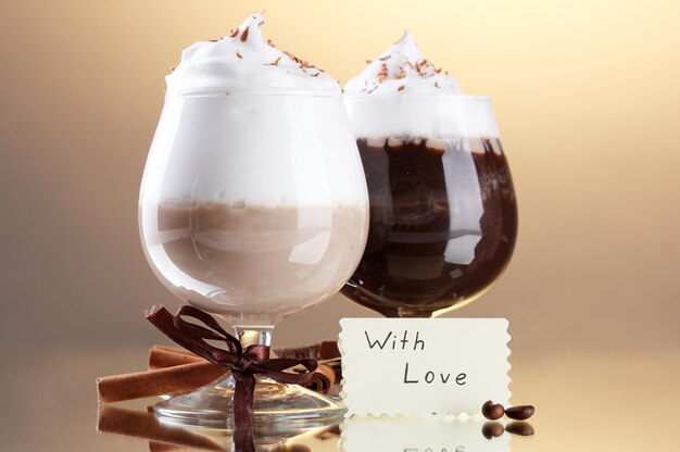 Glasses of coffee cocktail on brown background