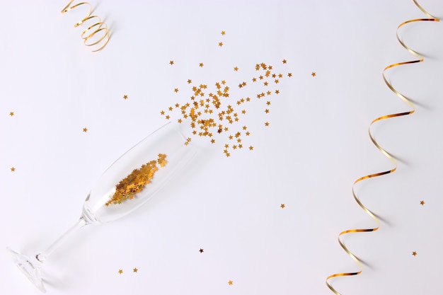 Glasses and confetti on a colored background top view