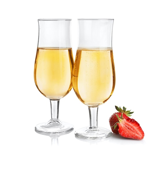 Glasses of delicious wine with strawberry on white background