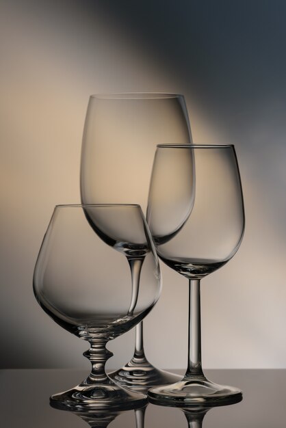 Glasses of different heights on a colored background