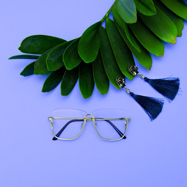 Glasses and Earrings. Stylish accessories for women. Flat lay