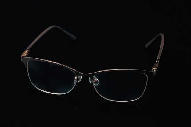 Glasses in fashionable frames on a black background