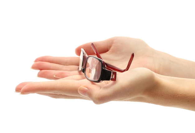 Glasses on female hands isolated on white