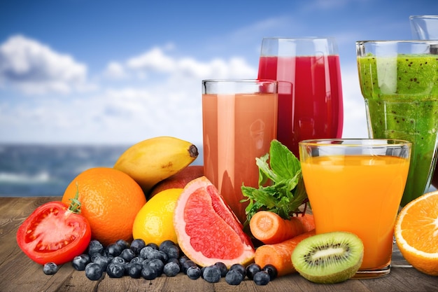 Glasses of fresh juice on  background