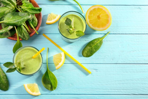 Glasses of fresh juice on wooden background