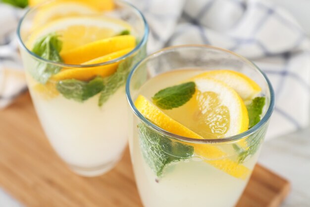 Glasses of fresh lemonade on table, close up