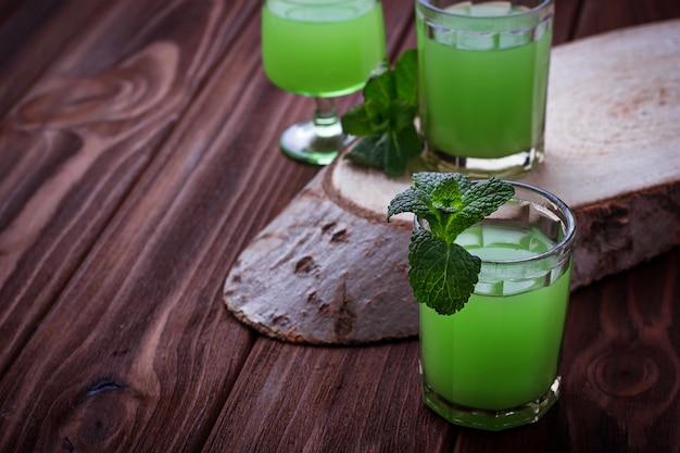 Glasses of green drink with mint