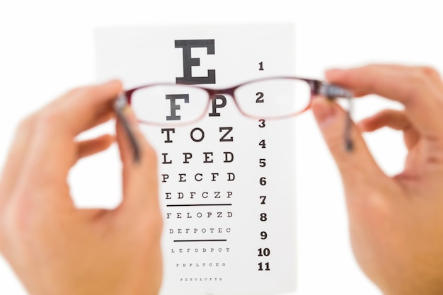 Glasses held up to read eye test