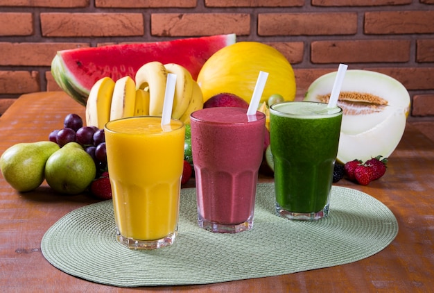 Glasses of juice with fresh fruits for summer.