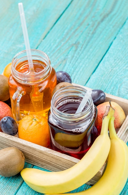 Glasses of juice with fruits