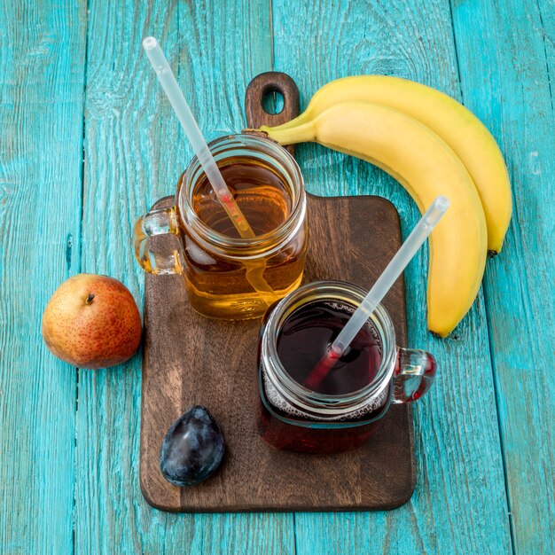 Glasses of juise with fruits on table