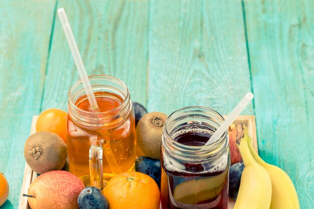 Glasses of juise with fruits on table