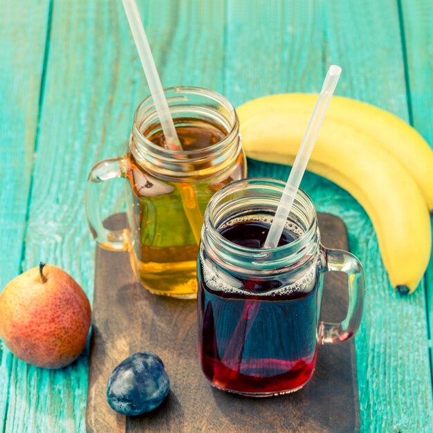 Glasses of juise with fruits on table