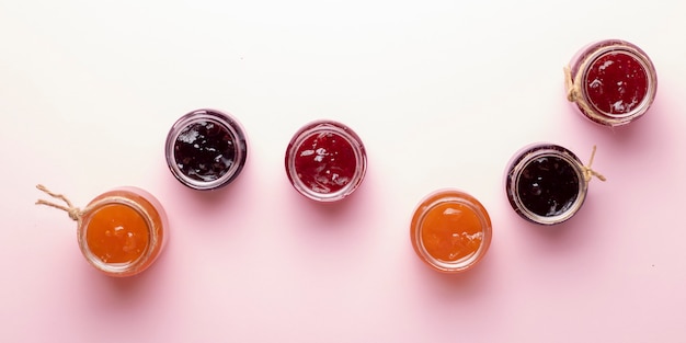 Glasses of mixed berry jam with strawberries, bilberries, red currants, raspberries and blackberries