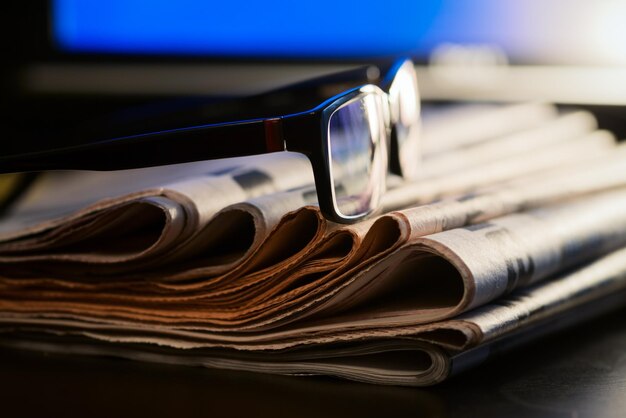 Glasses and newspapers journalism concept