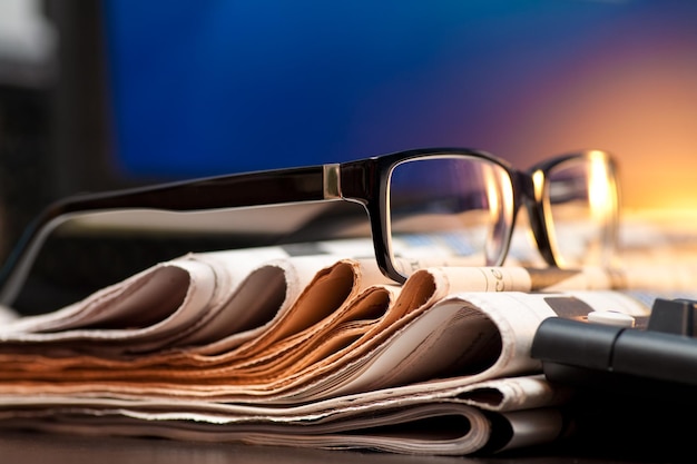 Glasses on newspapers