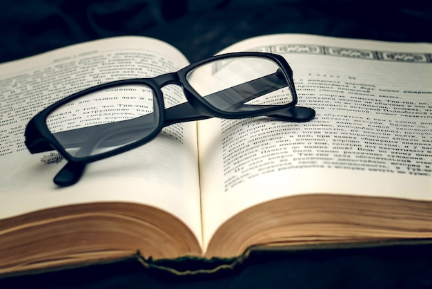 Glasses on old book