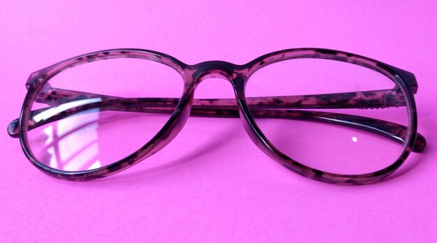 Glasses on a pink background View from above Place for text