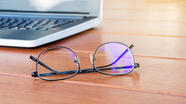 Glasses put near a laptop.