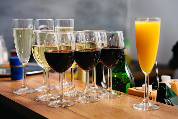Glasses of red and white wine with orange juice on bar counter Refreshments at the event