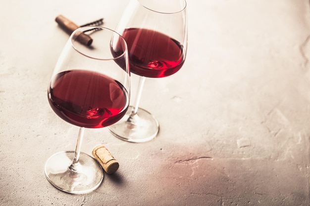 Glasses of red wine on concrete background copyspace