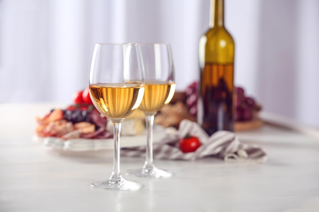 Glasses of red wine with food on table closeup