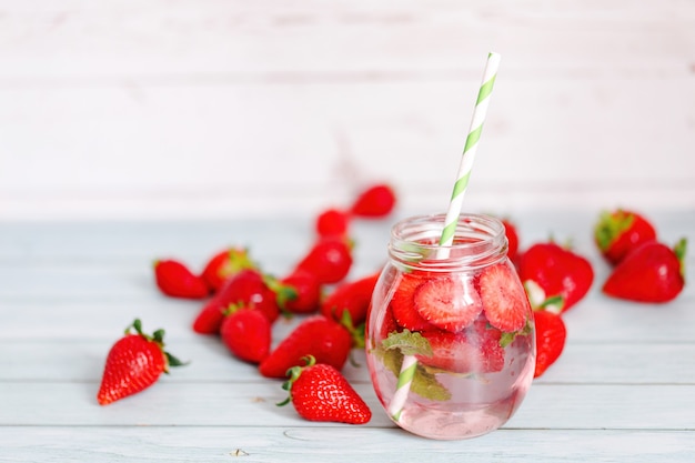Glasses of strawberries, mint infused water with ice