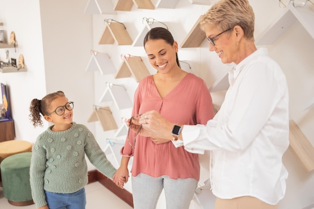 Glasses vision and children with a mother and daughter at the optometrist for an appointment to test prescription lenses Family consulting and eyewear with a woman customer buying frame lenses