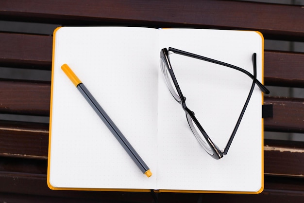 Glasses for vision on a notepad with a marker study concept