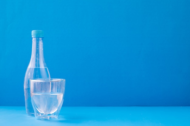 Glasses of water on blue background.