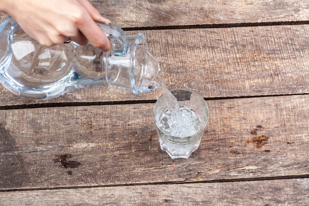 Glasses of water on a wooden table.