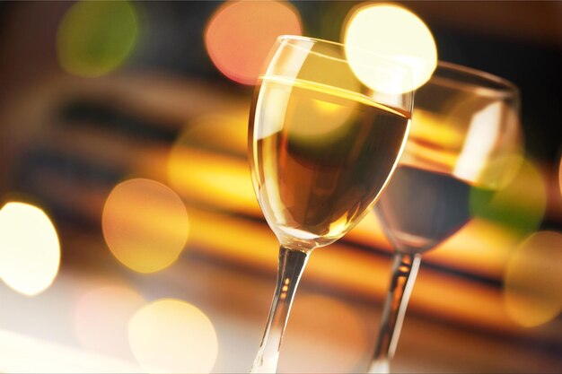 Glasses of white wine on dark background