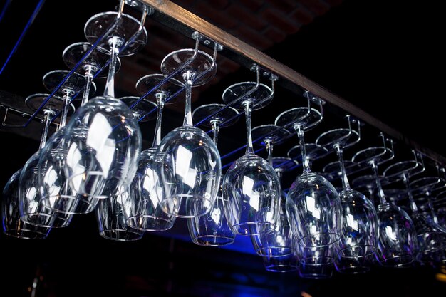 Glasses of wine Glasses hanging above the bar in the restaurant Empty glasses for wine