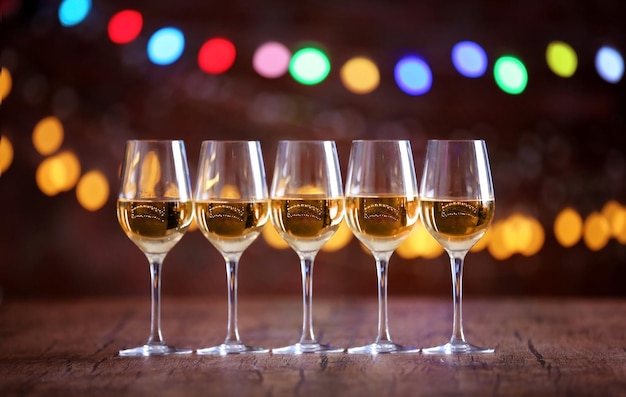 Glasses of wine in a row on bokeh background